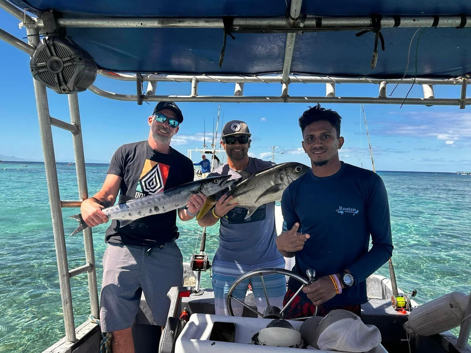 Boat cruising over Roatan waters