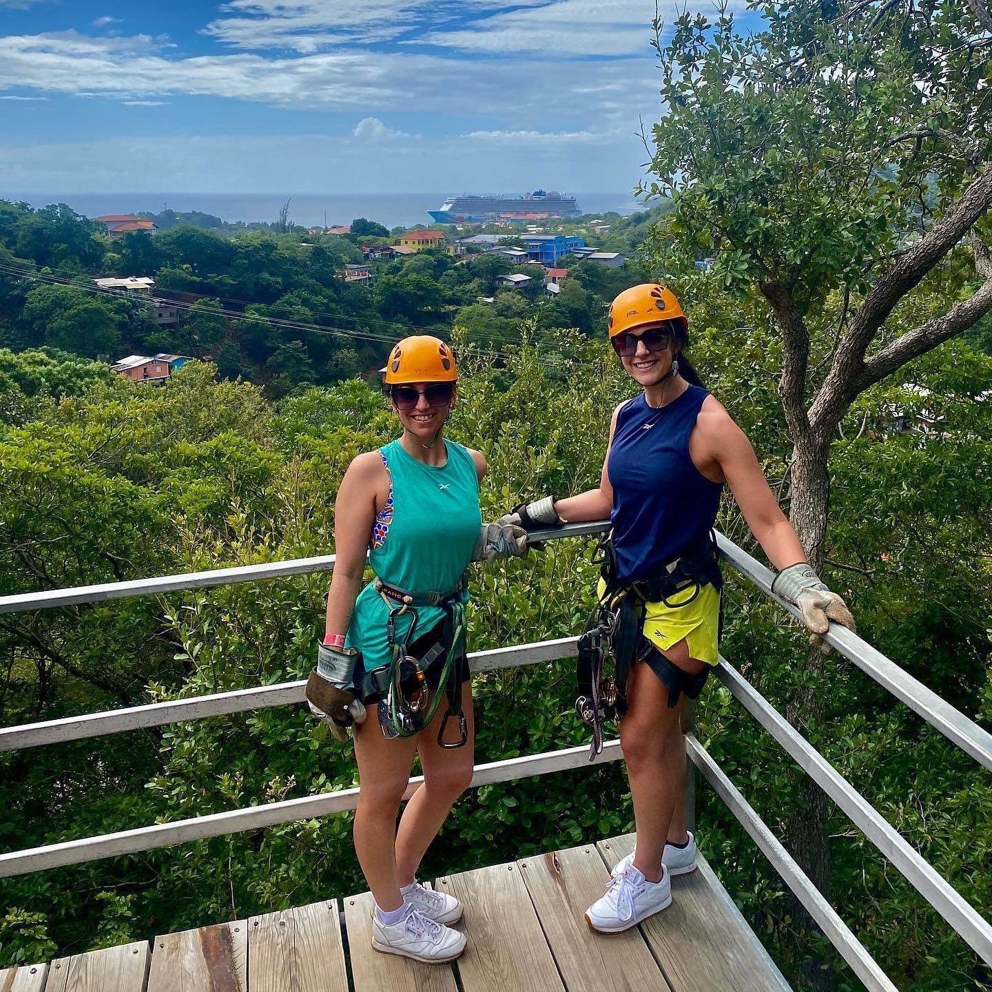 Person ziplining over jungle canopy